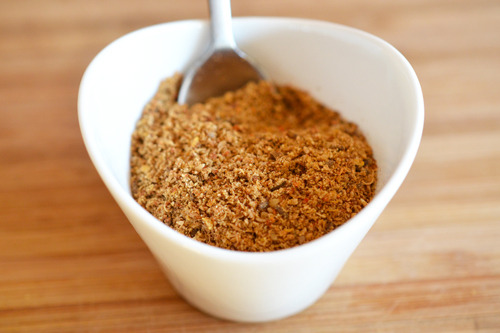 Tabil seasoning blend in a small bowl with a spoon inside.