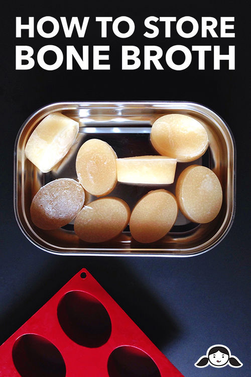 An overhead shot of frozen bone broth ovals in a stainless steel container