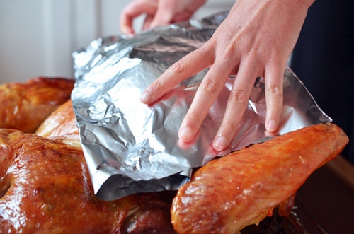 Placing foil on the breast part of a Spatchcock Turkey prevent it from overcooking in the oven.