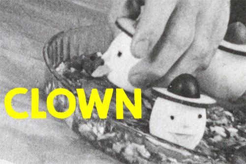 Bright yellow text "CLOWN" written over an image of crazy clown eggs.