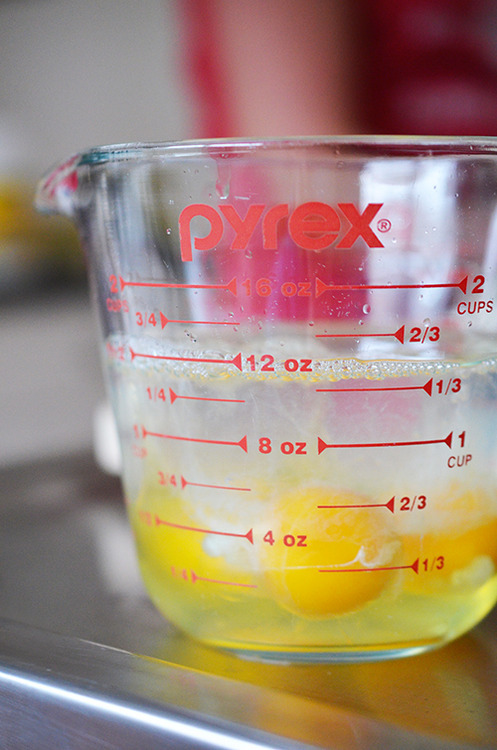 A closeup of the eggs and water in a measuring cup.