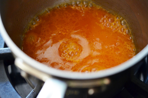 The sauce for the Orange Sriracha Chicken boiling in a pot.