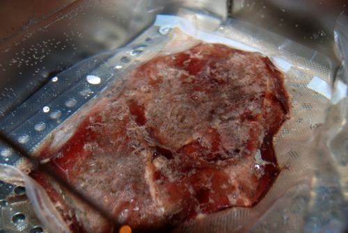 Vacuum sealed sirloin steak in a sous vide machine.