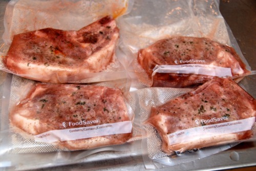 Seasoned pork chops with sagemary finishing salt and pepper, vacuum sealed to be cooked sous vide.