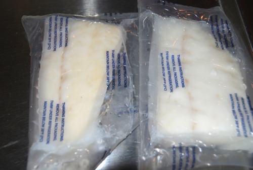 Two packages of frozen Alaska cod fillets.
