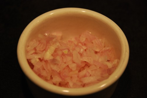 Chopped shallots prepped and in a ramekin.