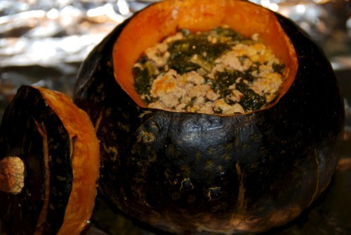 A cooked pork and spinach stuffed kabocha squash.