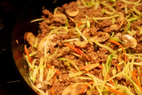 Broccoli slaw in a cast iron skillet with ground beef for paleo approved stir fried kelp noodle recipe.