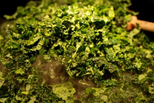 Thinly sliced kale in a cast iron skillet.