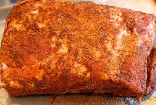 A pork butt seasoned with dry rub, salt, and pepper.