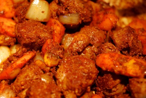 A close up of the browned vegetables with Rogan Josh seasoning on top.