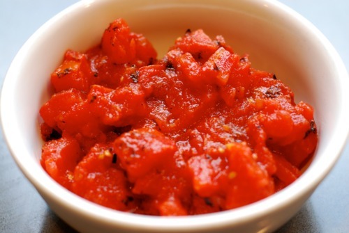 Diced fire roasted tomatoes from a can in a ramekin.