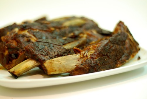 Close up of a rack of pork ribs cut up into individual ribs.