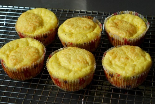 Baked cheesy egg muffins cooling on wire rack.