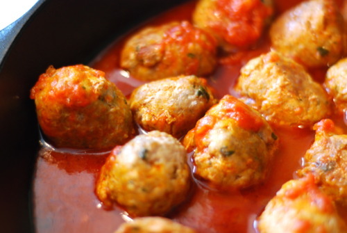 Meatballs cooking in a pan.