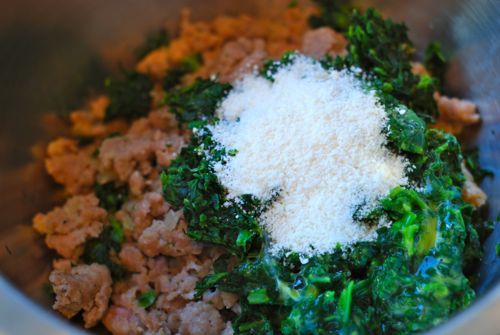 The sausage and spinach mixture for sausage and spinach stuffed portobello mushrooms in a bowl.