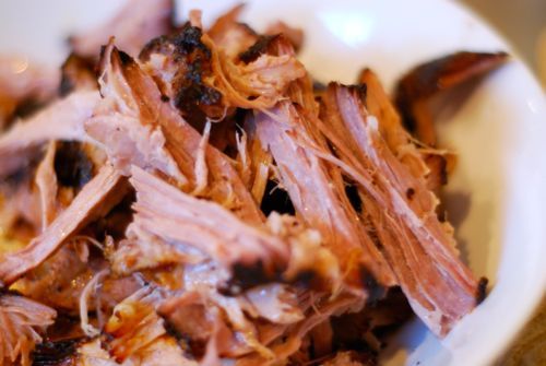 Shredded slow-roasted pork shoulder in a bowl.