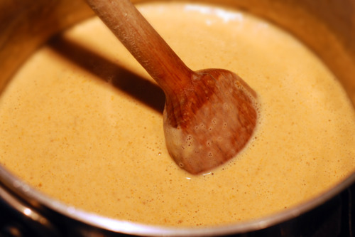 A Thai yellow curry marinade is simmering in a small saucepan.