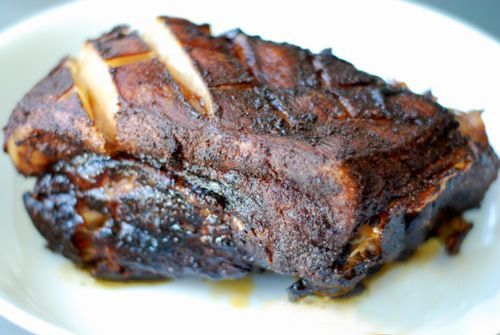Slow-roasted pork shoulder resting on a plate.