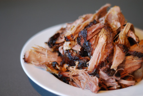 Shredded slow-roasted pork shoulder in a bowl.
