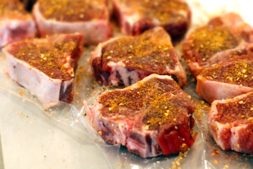 Goat loin chops are generously seasoned with dry rub mix.