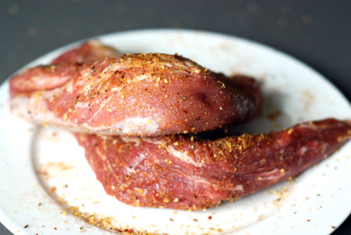 Raw pork tenderloin liberally seasoned with dry rub.
