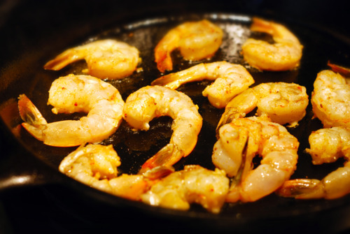 Whole shrimp frying in a pan.