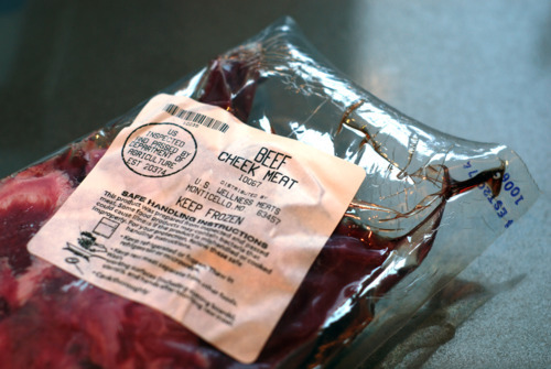A package of beef cheek meat sitting on a countertop.