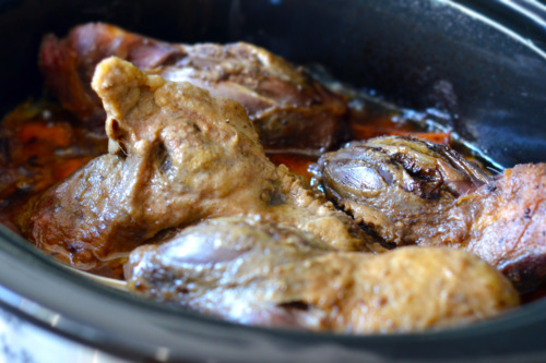 Slow cooker curried goat shanks are done cooking in the slow cooker.