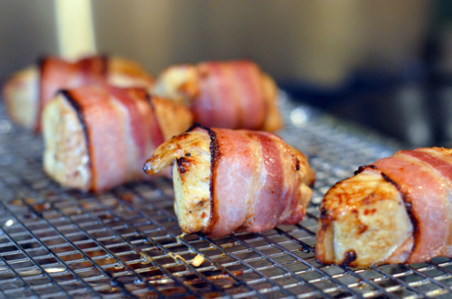 Cooked bacon-wrapped tuna on a wire rack.
