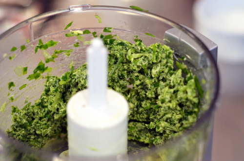 A butter herb paste in a food processor for broiled herb-stuffed sardines.