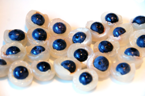 Longan and blueberry "eyeballs" assembled on a plate.