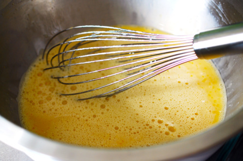 A mixing bowl with the pumpkin custard batter, including the eggs.