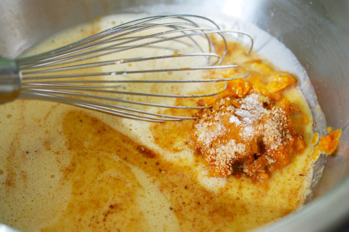 Pumpkin puree, vanilla extract, and salt are added to the custard mixture.