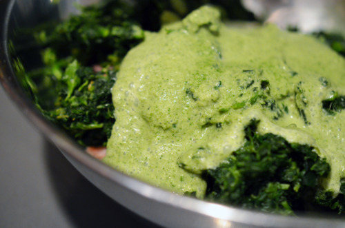 The green puree for the pork sliders is added into the bowl with the ground pork and defrosted spinach.