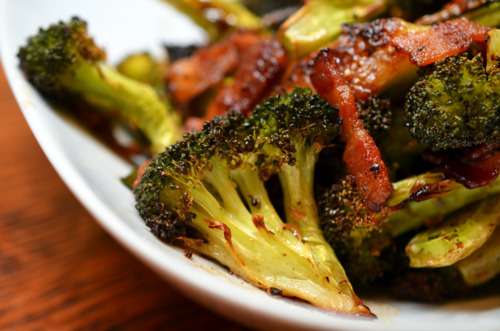 Close up side view of a platter of Whole30-friendly roasted broccoli and bacon.