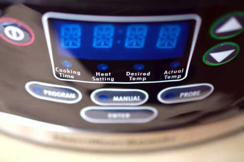 A close up of the buttons on a slow cooker.