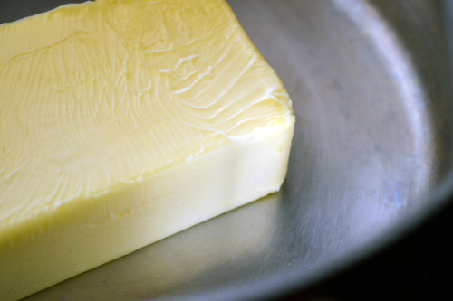Butter in a saucepan to make ghee.
