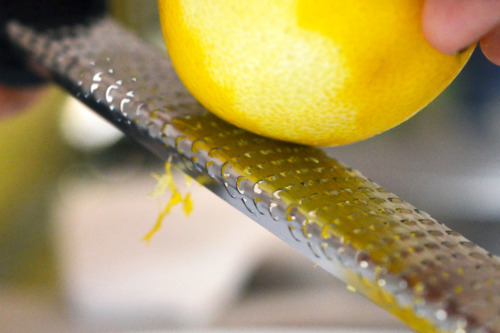 Zesting a lemon on a grater.