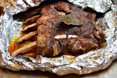 Cooked slow roasted ribs in a packet of aluminum foil.