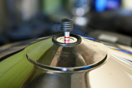 A closeup of the top of a stovetop pressure cooker.