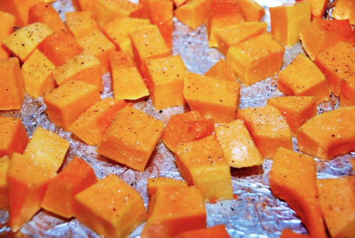Cubed pieces of butternut squash seasoned with ghee, salt, and pepper.