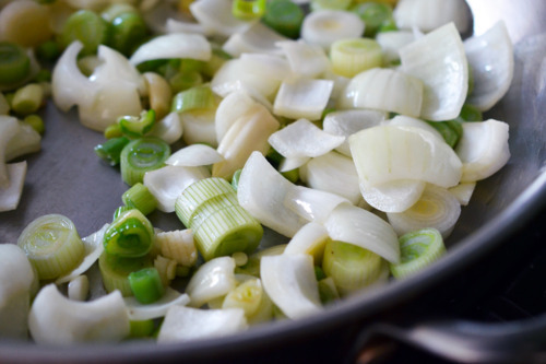 Sauteeing onions and leeks in a skillet.