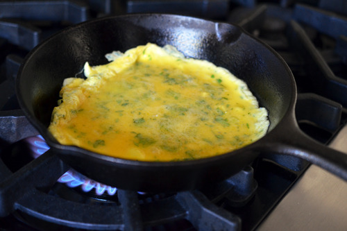Cooking the eggs undisturbed in a cast iron skillet.