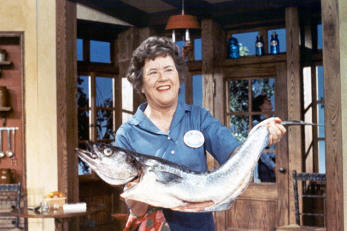 Julia Child holding a large fish.
