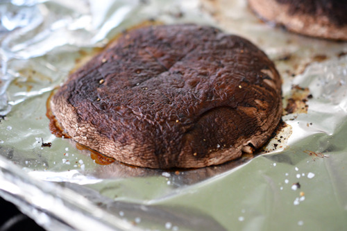 A portobello mushroom flipped gill-side down for the second half of the cooking process.