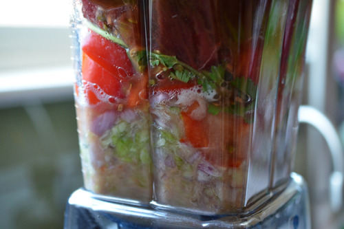 Blending some of the ingredients for watermelon and tomato gazpacho in a blender.