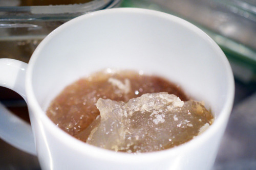 A cup filled with slow cooker beef bone broth.
