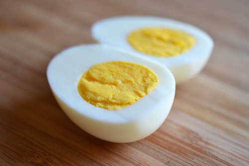 A perfectly hard-boiled egg cut in half to showcase the yolk.