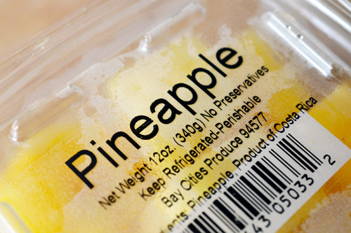 A plastic container packaged with pineapple.